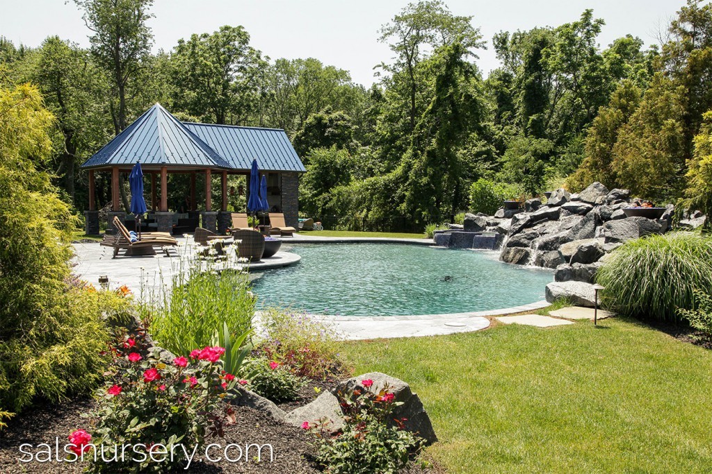 Pool with large boulder creating a very natural feel