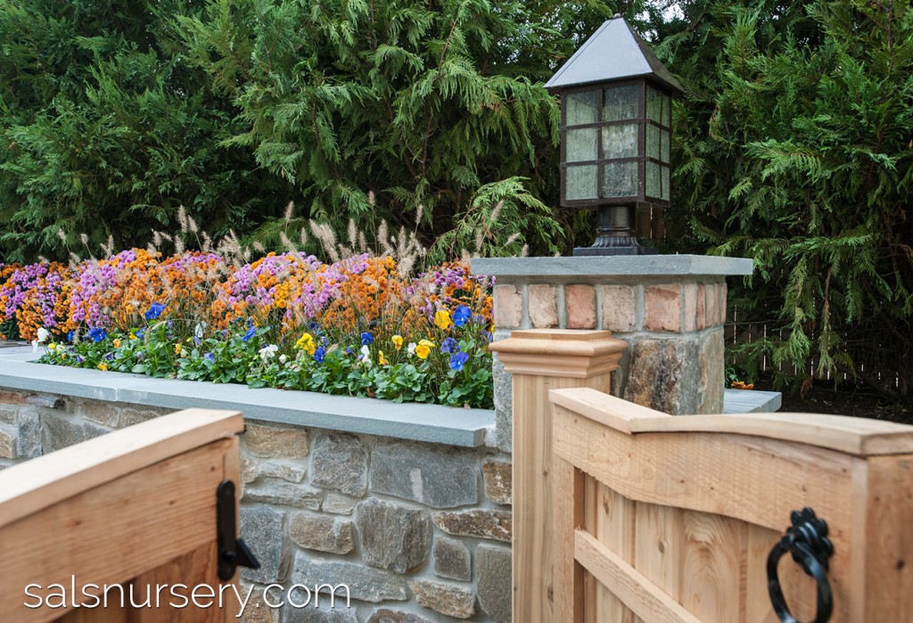 Stone Column with Light with stone retaining wall with flowers